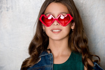 Valentine's Day. Beautiful girl with red heart sunglasses.
