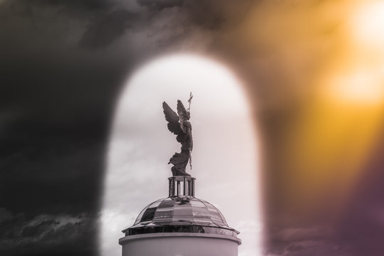 Archangel Michael sculpture against the sky in the arch.