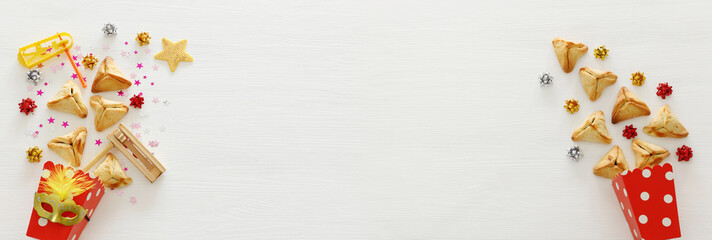 Purim celebration concept (jewish carnival holiday) over wooden white background. Banner.