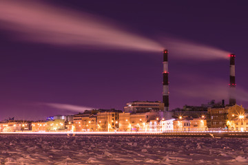 The winter night thermal power station on the Neva river embankment in Saint Petersburg, Russia