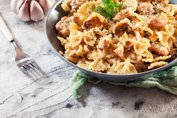 Creamy farfalle pasta with salmon, parmesan cheese and dill