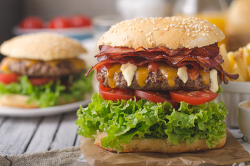 Homemade bacon burger with lettuce and cheddar