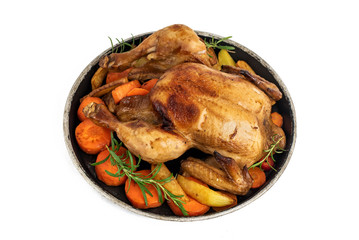 Roasted chicken, potatoes and vegetables in plate isolated on white background