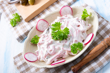 delicious homemade meat salad with mayonnaise and cucumber