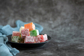 Turkish delight and cup of coffee on grey background. With copy space