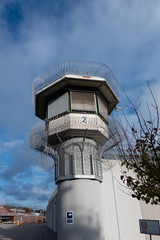 Watchtower of a correctional facility of a prison with a balustrade and two rows of barbed wire...