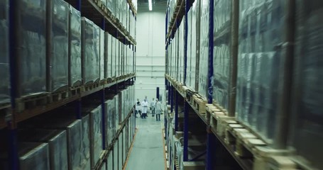 Workers in modern warehouse check the process of transportation.