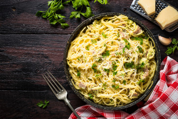 Pasta carbonara with bacon and cream sauce top view. 