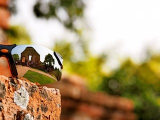 The reflection on a traveller's sunglasses at The Wat Ratchaburana, Ayutthaya, Thailand. This place also be one of ayutthaya historical park.