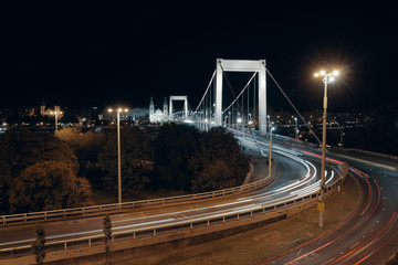 Picture of blurred car lights traveling through Elisabeth Bridge in Budapest, Hungary