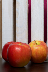 Ripe juicy apples. Against the background of a wooden box.