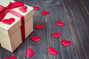 gift box and red heart on wooden table background with copy space.