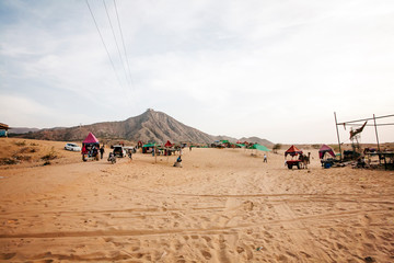 Pushkar Desert, Rajasthan, India, February 2018: Pushkar desert with camels and vehicles