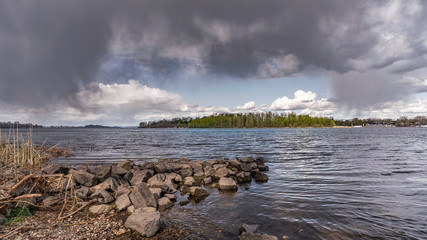 Dark heavy clouds in the sky over the Dnieper river announce the incoming of a spring storm over the city of Kiev, Ukraine
