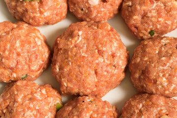 Top view: nine fresh uncooked meat balls prepared for cooking. Concept: pre-prepared food.
