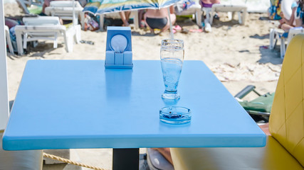 just drank a glass of beer on the table at the beach bar in the open air