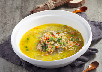 Boiled rice noodles with sour soup in a white pot