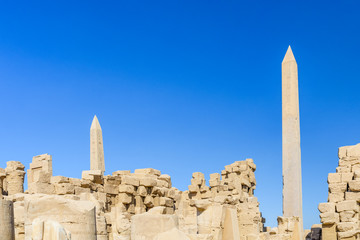 Granite obelisk against blue sky in a Karnak temple. Luxor, Egypt.