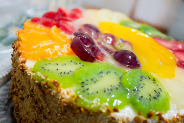 Colorful jelly fruit cake with kiwi, grapes, orange. Close up