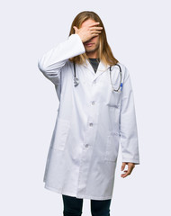 Doctor man covering eyes by hands. Do not want to see something on isolated background