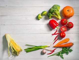 Assortment of fresh vegetables on a white wooden background. Top view