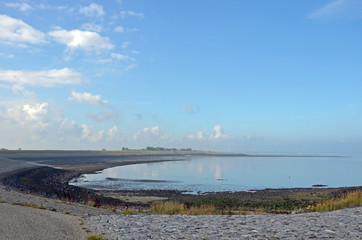 A predominantly blue sky with some scattered clouds over the sandy north coast of the island of Noord-Beveland, The Netherlands and Oosterschelde estuary