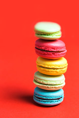 Close-up of a column of colorful macaroon on a red background
