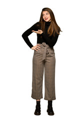 Full-length shot of Pretty girl presenting an idea while looking smiling towards on isolated white background