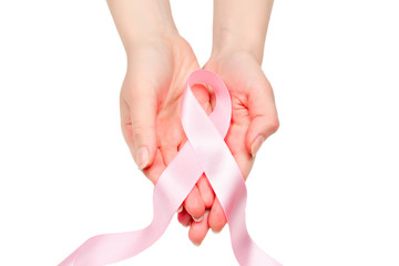 Pink ribbon in woman hands isolated on white. Breast Cancer Awareness ribbon.