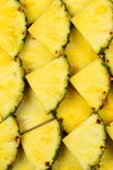 Fototapeta na wymiar Pineapple juicy yellow slices background. Top view.