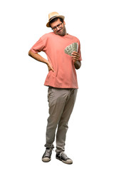 Man holding many bills suffering from backache for having made an effort on isolated white background