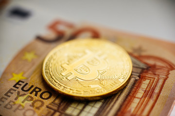 Bitcoin, Currency, digital, finance, economy. Golden bitcoin coin on Euro close up