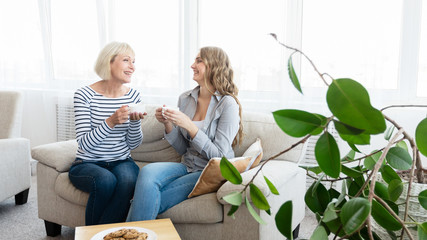 Mother and daughter spending time together, drinking coffee