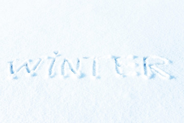 Text Hello winter and little blue pail of snow. Pastel color, snowy greeting card. Winter holidays concept.