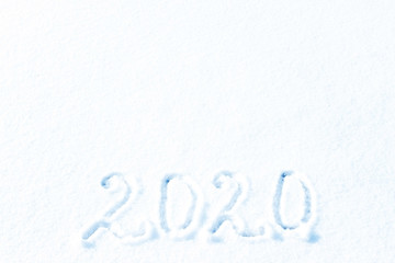2020 New year. 2020 year painted on a snowy background. Figures two thousand and twenty of snow.