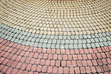 multi-colored pavement of different bricks, leaving a semicircular pavement