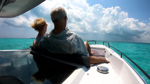 Senior couple on yacht enjoying vacation sailing Bahamas