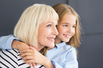Senior woman and little girl spending time together