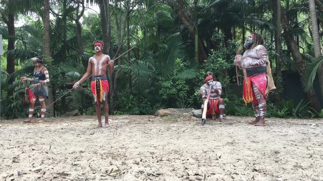 Indigenous Australian's People dancing to didgeridoo musical instrument sound rhythm in Queensland, Australia.