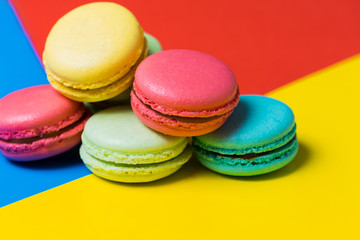 Fototapeta na wymiar Sweet and colourful french macaroons or macaron on colorful background