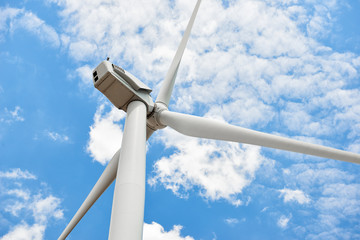The wind generator is in bright cloudy sky. Eco energy concept.