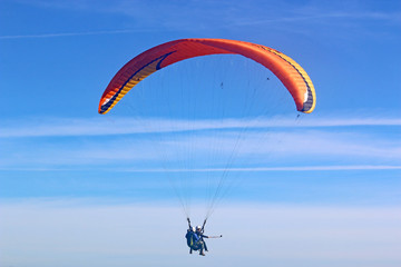 Tandem paraglider flying