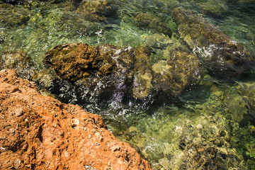 tropic sea rocky coast photography from above to waves and drops in transparent water and shallow bottom scenic landscape