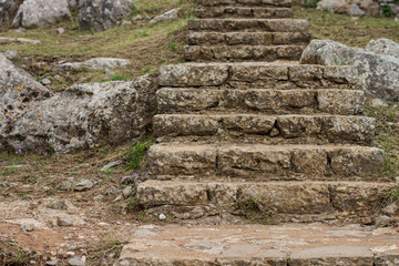 Fototapeta na wymiar stone stairs path way inside destroyed in time medieval castle fortress in rocky highland environment 