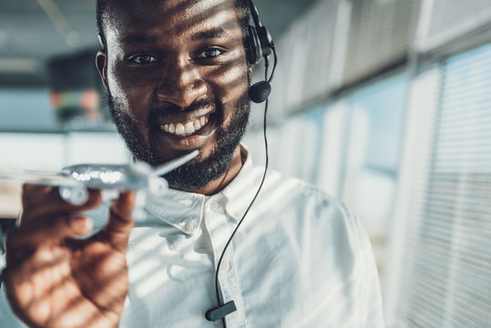 Close up of young man with airplane model