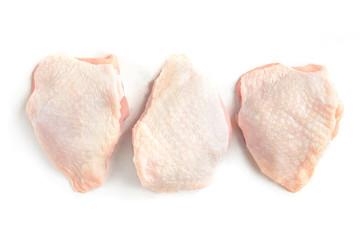 Raw chicken thighs isolated on white background.