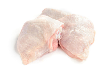 Raw chicken thighs isolated on white background.