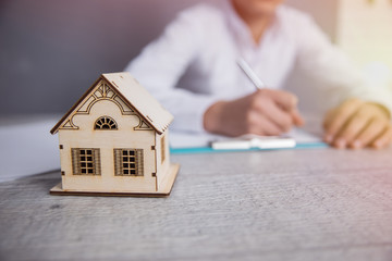 hand document and house model