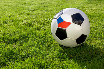 Fototapeta premium Football on a grass pitch with Czech Republic Flag