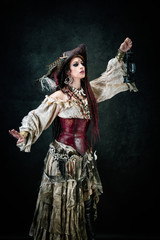Sexy pirate, profile, holding an oil lamp